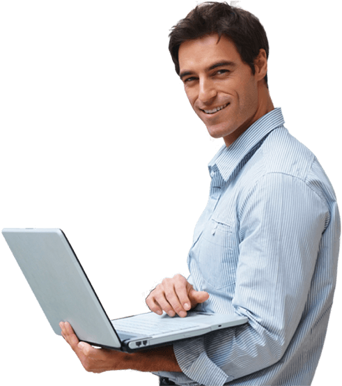 Man standing and holding a laptop while smiling at the camera